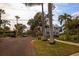 Picturesque street view on a sunny day, featuring homes, palm trees, and a four way stop at 145 10Th N Ave # 8, St Petersburg, FL 33701