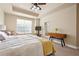 Bright bedroom featuring a trey ceiling, ceiling fan, large window, and ensuite bathroom at 14543 Mirabelle Vista Cir, Tampa, FL 33626