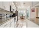 Modern kitchen featuring white cabinetry, stainless steel appliances, and an eat-in area at 14543 Mirabelle Vista Cir, Tampa, FL 33626