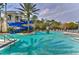 Resort-style pool featuring a water slide and fountain, surrounded by lounge chairs at 14543 Mirabelle Vista Cir, Tampa, FL 33626