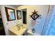 Bright bathroom with a sink, decorative starfish, and a clean, functional design at 1670 Monterey Dr, Clearwater, FL 33756