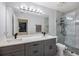 Modern bathroom featuring dual sinks, spacious vanity, and a glass-enclosed shower at 20327 Merry Oak Ave, Tampa, FL 33647