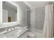 Clean, well-lit bathroom with a large mirror and a shower-tub combination at 20327 Merry Oak Ave, Tampa, FL 33647