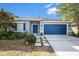 Charming one-story home with blue door, shutters and well-manicured landscaping at 20327 Merry Oak Ave, Tampa, FL 33647