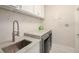 Well-organized laundry room featuring countertop, modern appliances, and storage cabinets at 20327 Merry Oak Ave, Tampa, FL 33647