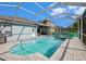 A beautiful pool with clear blue water inside of a screened-in pool area at 20327 Merry Oak Ave, Tampa, FL 33647