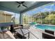 Screened-in pool with an attached spa and plenty of seating area at 20327 Merry Oak Ave, Tampa, FL 33647