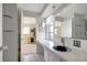 Bathroom with a vanity, large mirror, and a view into a bedroom at 2054 Envoy Ct, Clearwater, FL 33764