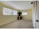 Empty bedroom with light-yellow walls, carpet, and built-in corner desk at 2054 Envoy Ct, Clearwater, FL 33764