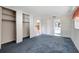 Simple bedroom with blue carpet and a view of the bathroom at 2054 Envoy Ct, Clearwater, FL 33764