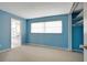 Bedroom with light blue walls, carpet, and a view into the kitchen at 2054 Envoy Ct, Clearwater, FL 33764