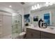 Modern bathroom with a glass-enclosed shower, double sinks, and stylish decor at 2075 Hallier Cv, Wesley Chapel, FL 33543