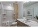 Bright bathroom featuring a shower-tub combo, a vanity, and ample lighting at 2075 Hallier Cv, Wesley Chapel, FL 33543