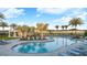 Community pool with lounge chairs and palm trees, perfect for relaxing and enjoying the Florida sunshine at 2075 Hallier Cv, Wesley Chapel, FL 33543