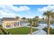 Resort-style pool area with tropical landscaping, seating, and clubhouse at 2101 Hallier Cv, Wesley Chapel, FL 33543