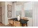 Modern dining room with a black table, woven chairs, and natural light from large windows at 2127 Hallier Cv, Wesley Chapel, FL 33543