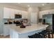 Modern kitchen featuring stainless steel appliances, white cabinets, and a center island with seating at 2127 Hallier Cv, Wesley Chapel, FL 33543