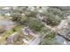 Aerial view of a suburban home surrounded by mature trees, showcasing the property's setting at 24121 Landing Dr, Lutz, FL 33559