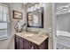 Bathroom featuring a vanity with granite countertop, a framed mirror and artwork at 24121 Landing Dr, Lutz, FL 33559