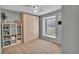 Bedroom with a neutral color palette, featuring a large window, built in storage, and neutral carpeting at 24121 Landing Dr, Lutz, FL 33559