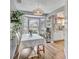 Cozy breakfast nook featuring a bay window, plants, a dining table and adjacent kitchen space at 24121 Landing Dr, Lutz, FL 33559