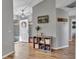 Welcoming entryway with wood floors, a storage shelf, and a view of the front door and the open floorplan at 24121 Landing Dr, Lutz, FL 33559