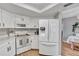 Well-lit kitchen with white appliances, plenty of counter space, and views to the dining area at 24121 Landing Dr, Lutz, FL 33559