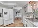 Bright kitchen featuring stainless steel appliances, white cabinetry, and a view of the dining area with a table at 24121 Landing Dr, Lutz, FL 33559