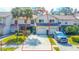 Aerial view shows a charming townhome boasts an attached garage, lush landscaping, and a desirable curb appeal at 2559 Stony Brook Ln, Clearwater, FL 33761