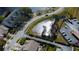 Aerial view of community with a pond, roads, and parking at 2559 Stony Brook Ln, Clearwater, FL 33761