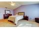 Bedroom features soft carpet, ceiling fan, and a dark wood dresser with decorative mirror at 2559 Stony Brook Ln, Clearwater, FL 33761