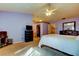 Bedroom with open closet features soft carpet, ceiling fan, and a dark wood dresser with mirror at 2559 Stony Brook Ln, Clearwater, FL 33761