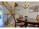 Dining area with a charming chandelier, stairs, and a dark wood table at 2559 Stony Brook Ln, Clearwater, FL 33761