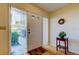 Bright entryway featuring a door with glass panels and a wooden accent table at 2559 Stony Brook Ln, Clearwater, FL 33761