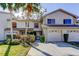 Charming townhome featuring an attached garage, well-maintained landscaping, and a welcoming entrance at 2559 Stony Brook Ln, Clearwater, FL 33761