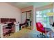 Home office with multiple desks, a chair and a mirror closet at 2559 Stony Brook Ln, Clearwater, FL 33761