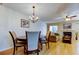 Cozy living room featuring a fireplace, wood floors, and a dining area chandelier at 2559 Stony Brook Ln, Clearwater, FL 33761