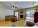 A living room with a ceiling fan, fireplace, sliding glass doors and wood floors at 2559 Stony Brook Ln, Clearwater, FL 33761