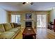 Inviting living room with sliding doors that lead to the outdoor patio area and a fireplace at 2559 Stony Brook Ln, Clearwater, FL 33761