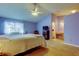 Comfortable main bedroom with soft carpet, ceiling fan and a tranquil view at 2559 Stony Brook Ln, Clearwater, FL 33761