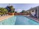 A sparkling community pool offers residents a refreshing escape during warm days, surrounded by privacy fencing at 2559 Stony Brook Ln, Clearwater, FL 33761