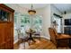 Bright breakfast nook featuring hardwood floors, a charming chandelier, and a picturesque outdoor view at 26890 Hiawatha Blvd, Brooksville, FL 34601