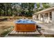 Inviting hot tub with wood paneling, surrounded by a patio and lush greenery at 26890 Hiawatha Blvd, Brooksville, FL 34601