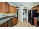 Spacious kitchen with tile floors, stainless steel appliances, and a view into laundry room at 26890 Hiawatha Blvd, Brooksville, FL 34601