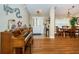 Inviting living room and dining area with hardwood floors, an upright piano, and lots of natural light at 26890 Hiawatha Blvd, Brooksville, FL 34601