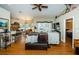 Open-concept living room featuring wood floors, ceiling fan, and glass doors to the backyard at 26890 Hiawatha Blvd, Brooksville, FL 34601