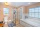 Bathroom featuring a glass shower, soaking tub with tile surround, and a large vanity at 26890 Hiawatha Blvd, Brooksville, FL 34601