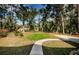 Beautifully maintained yard featuring a winding walkway, ideal for enjoying peaceful strolls and outdoor relaxation at 26890 Hiawatha Blvd, Brooksville, FL 34601