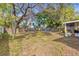 Spacious backyard with green lawn, mature trees, hammock and partial fencing at 2819 47Th S Ave, St Petersburg, FL 33712