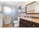 Bathroom featuring a walk-in shower with glass doors, a granite countertop vanity, and tiled walls at 2819 47Th S Ave, St Petersburg, FL 33712